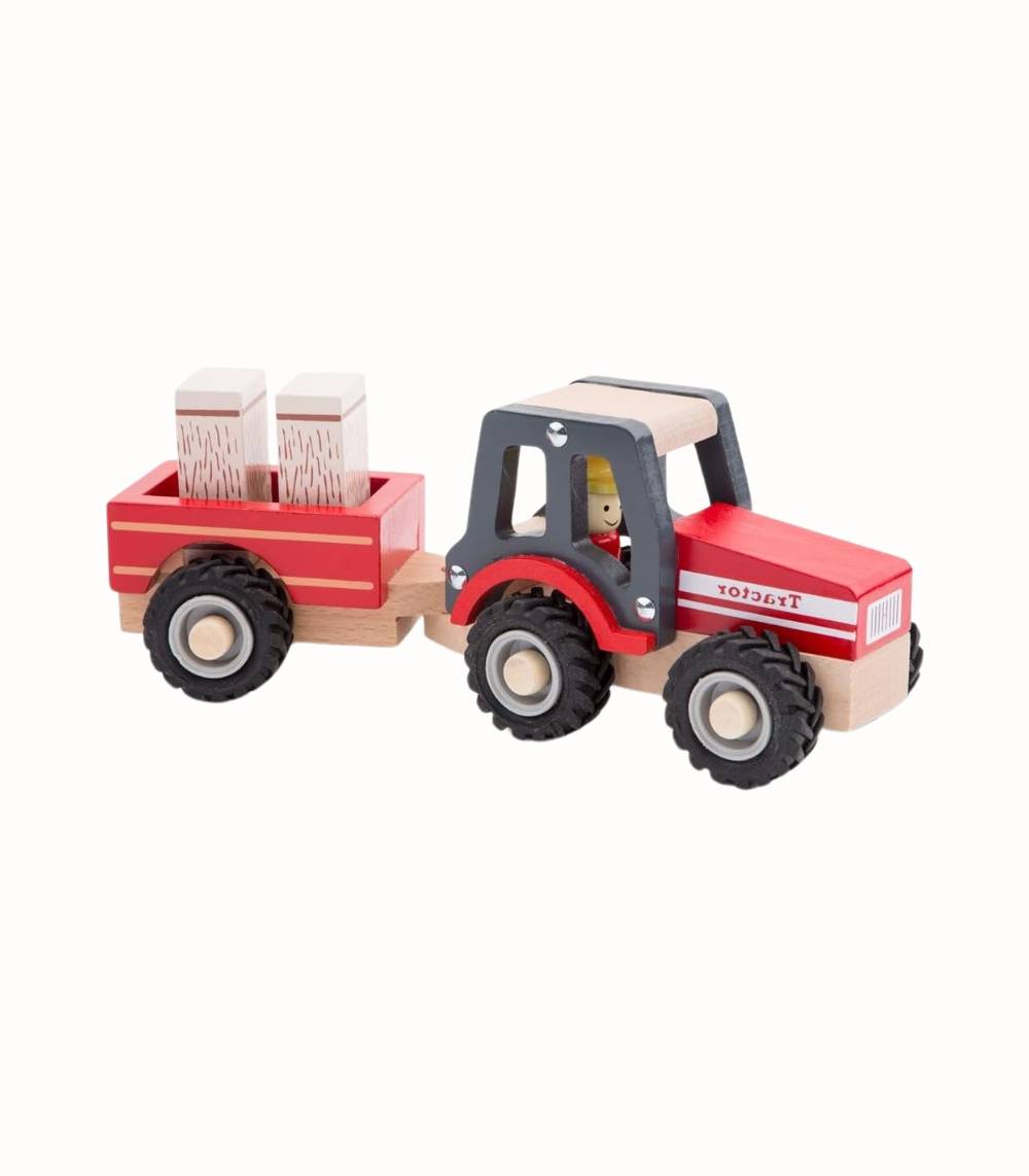 Trätraktor med släp och höbalar